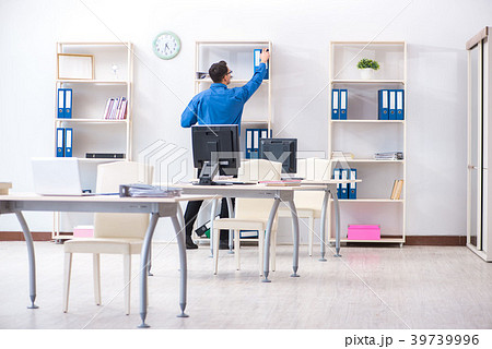 Handsome businessman employee sitting at his desk Handsome businessman employee sitting at his desk 39739996