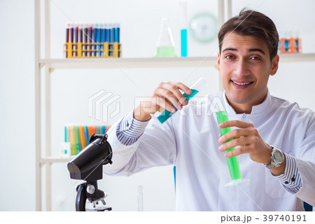 Young chemist student working in lab on chemicals Young chemist student working in lab on chemicals 39740191