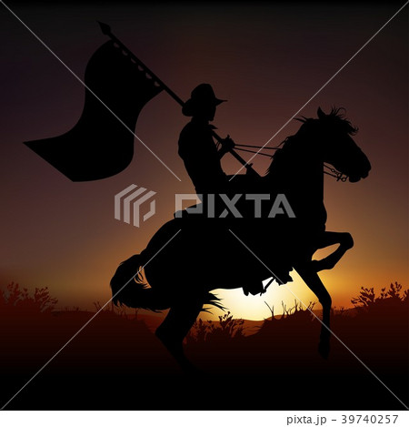 Silhouetted Horseback Cowboy with a Flag Silhouetted Horseback Cowboy with a Flag 39740257