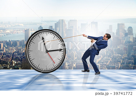 Businessman in time management concept Businessman in time management concept 39741772