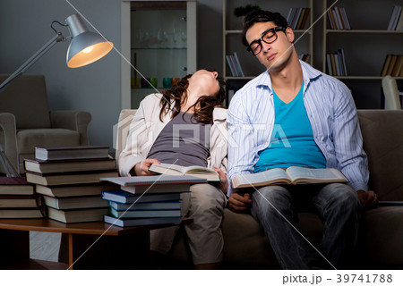 Two students studying late preparing for exams Two students studying late preparing for exams 39741788