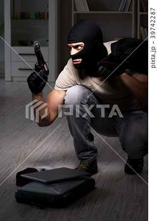 Burglar wearing balaclava mask at crime scene 39742287