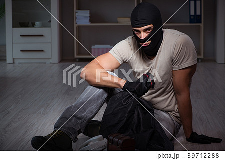 Burglar wearing balaclava mask at crime scene 39742288