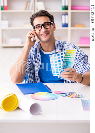 Young designer working on new project and choosing 39742411