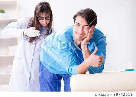 Funny man getting ready for buttocks syringe shot 39742613