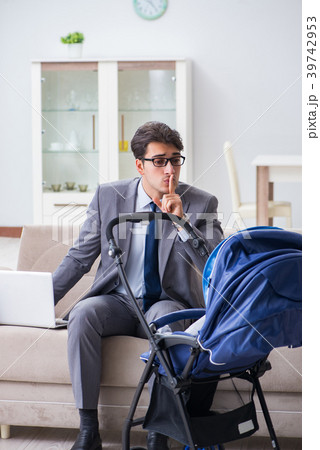 Businessman looking after newborn baby at home and Businessman looking after newborn baby at home and 39742953