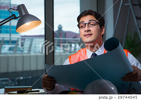 Construction architect working on drawings late at Construction architect working on drawings late at 39744045