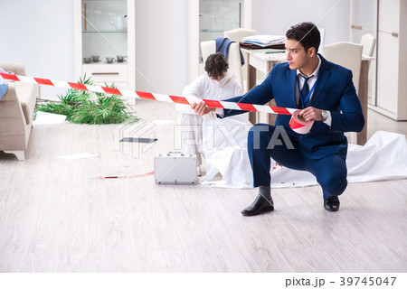 Forensics investigator at the scene of office 39745047