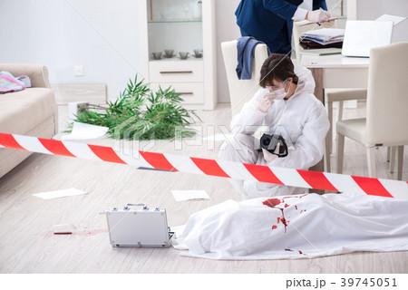 Forensics investigator at the scene of office 39745051