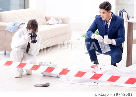 Forensics investigator at the scene of office 39745083
