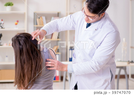 Doctor checking patients joint flexibility 39747070