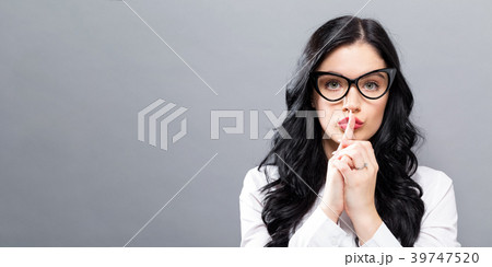 Young woman making a quiet gesture Young woman making a quiet gesture 39747520