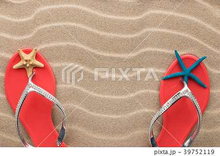 Pink flip flops and starfish on the sand of beach Pink flip flops and starfish on the sand of beach 39752119