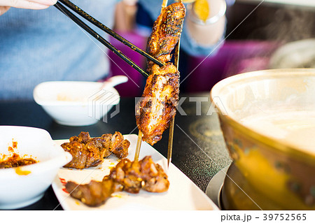 Woman taking barbeque from stick close up 39752565