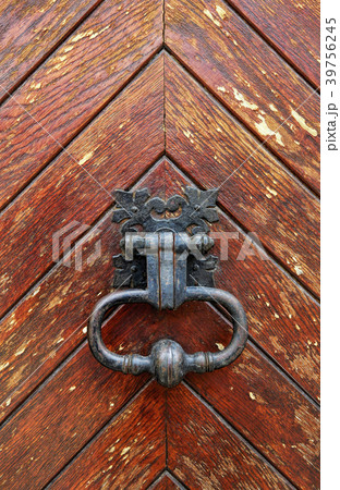 Vintage knocker close-up on wooden door background Vintage knocker close-up on wooden door background 39756245