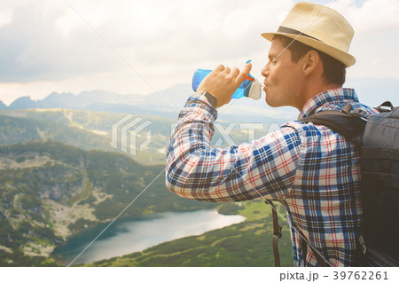 Traveler drinks water in the mountains Traveler drinks water in the mountains 39762261