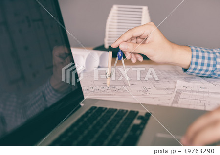 Engineering man hand drawing on blueprint Engineering man hand drawing on blueprint 39763290