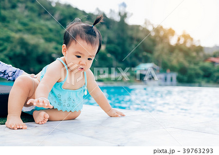 Baby infant tries to crawl down to the pool alone 39763293