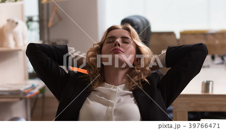 Young beautiful businesswoman is relaxing at Young beautiful businesswoman is relaxing at 39766471