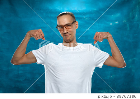 Cute man posing on blue background Cute man posing on blue background 39767386