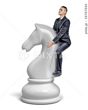 A small businessman rides a giant white chess A small businessman rides a giant white chess 39767694