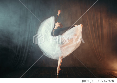 Ballet dancer in motion on the stage in theatre Ballet dancer in motion on the stage in theatre 39767976