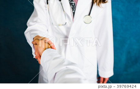 Two doctors shaking hands close up Two doctors shaking hands close up 39769424