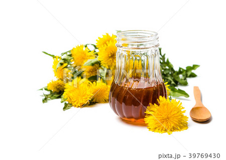 Dandelion flowers and honey jar isolated on white Dandelion flowers and honey jar isolated on white 39769430