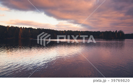 Colorful clouds over still lake in evening Colorful clouds over still lake in evening 39769820