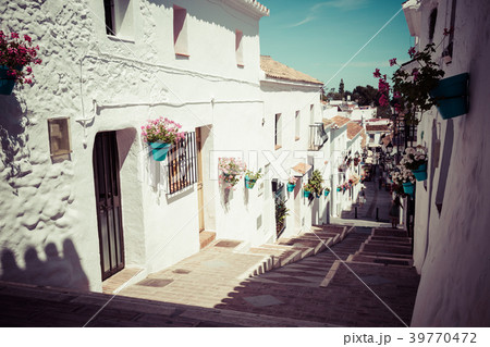 Picturesque street of Mijas with flower pots Picturesque street of Mijas with flower pots 39770472