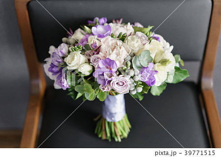 Brides wedding bouquet with peonies, freesia and 39771515