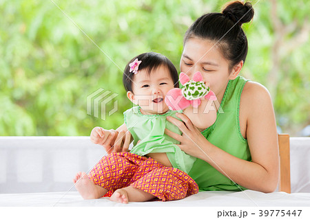 asian baby girl smiling and playing with mother asian baby girl smiling and playing with mother 39775447