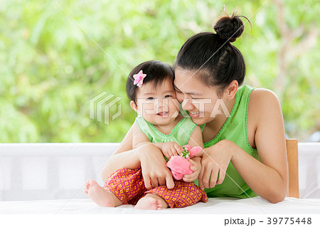 asian baby girl smiling and playing with mother asian baby girl smiling and playing with mother 39775448