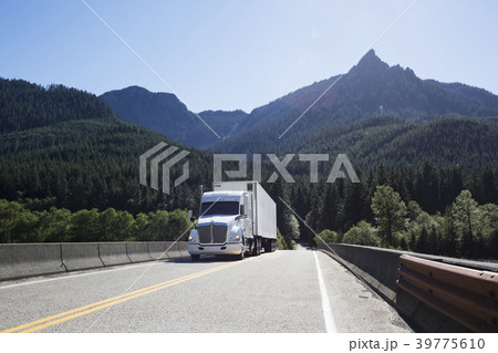 Commercial truck on a highway in the mountains east of Seattle, Washington USA Commercial truck on a highway in the mountains east of Seattle, Washington USA 39775610