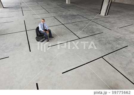 Asian businessman taking a look at a large empty raw office space. 39775662