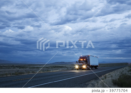 Commercial truck on the road at sunset. 39775704