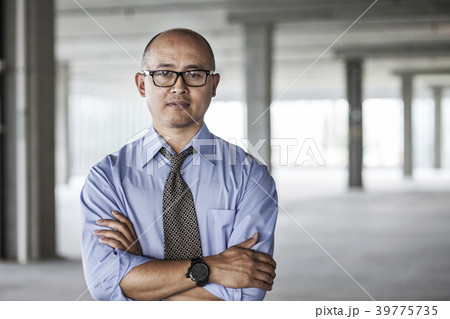 Asian businessman taking a look at a large empty raw office space. 39775735