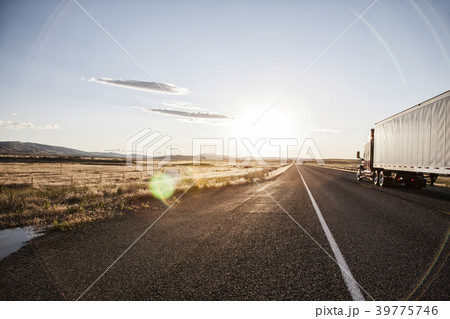 Side view of a trailer and truck on the road at sunset in eastern Washington, USA Side view of a trailer and truck on the road at sunset in eastern Washington, USA 39775746