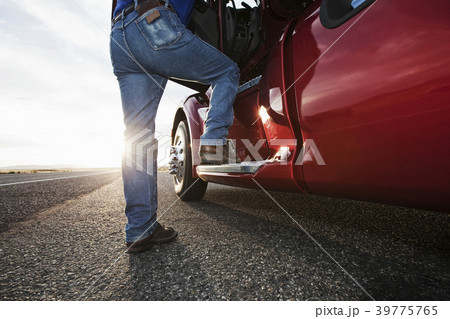 Driver getting into the cab of a commercial truck. Driver getting into the cab of a commercial truck. 39775765
