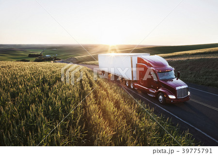 commercial truck driving though wheat fields of eastern Washington, USA at sunset. 39775791