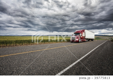 Commercial truck driving though wheat fields of eastern Washington, USA at sunset. Commercial truck driving though wheat fields of eastern Washington, USA at sunset. 39775813