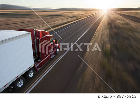 View from behind and above a  commercial truck on the road at sunset on a highway in eastern Washington, USA 39775815