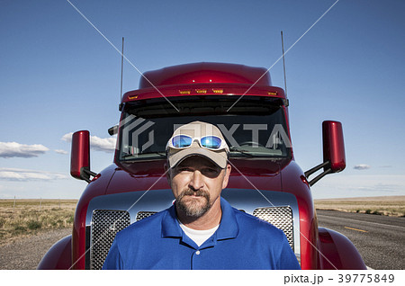Portrait of a Caucasian man driver and his commercial truck. Portrait of a Caucasian man driver and his commercial truck. 39775849