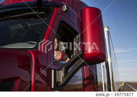 View of a Caucasian woman driver in the cab of her  commercial truck. 39775877
