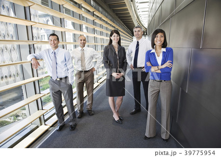 Mixed race team of business people in the lobby of a large office building. Mixed race team of business people in the lobby of a large office building. 39775954