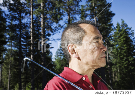 A senior golfer ready to approach the next shot on a golf course. A senior golfer ready to approach the next shot on a golf course. 39775957
