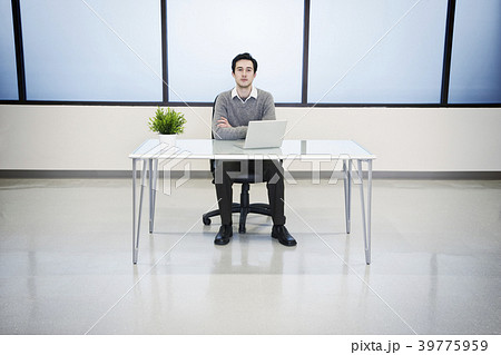 A Caucasian man lab technician working in the office of a computer server farm. 39775959
