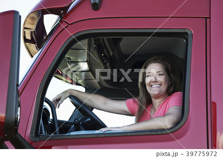 Portrait of a Caucasian woman driver and her commercial truck. Portrait of a Caucasian woman driver and her commercial truck. 39775972