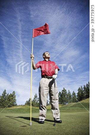 A senior golfer ready to approach the next shot on a golf course. A senior golfer ready to approach the next shot on a golf course. 39775975