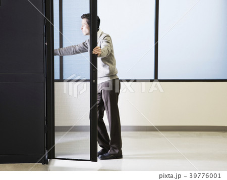 Caucasian male technician working on computer servers in a computer server farm. Caucasian male technician working on computer servers in a computer server farm. 39776001